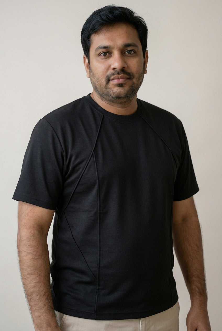 Side profile of  a man wearing Carbon Black structured tee showing clean drape and improved fit for midsection